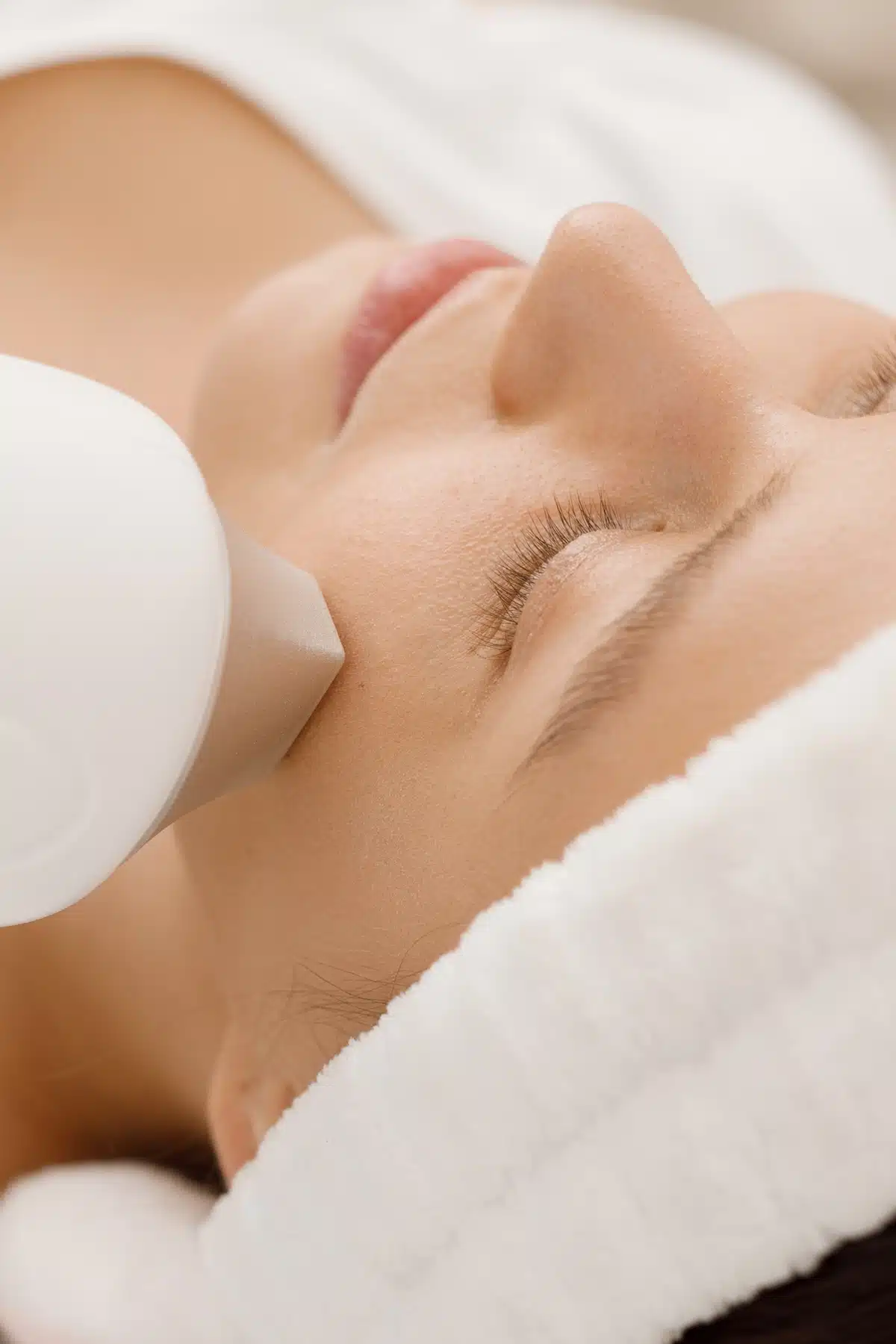 woman receiving laser facial treatment woman receiving laser facial treatment